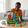 Boy leaning over a wooden table, magnetic building blocks category