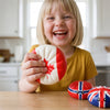 Girl laughing with her hands pressed together, squishy toys category