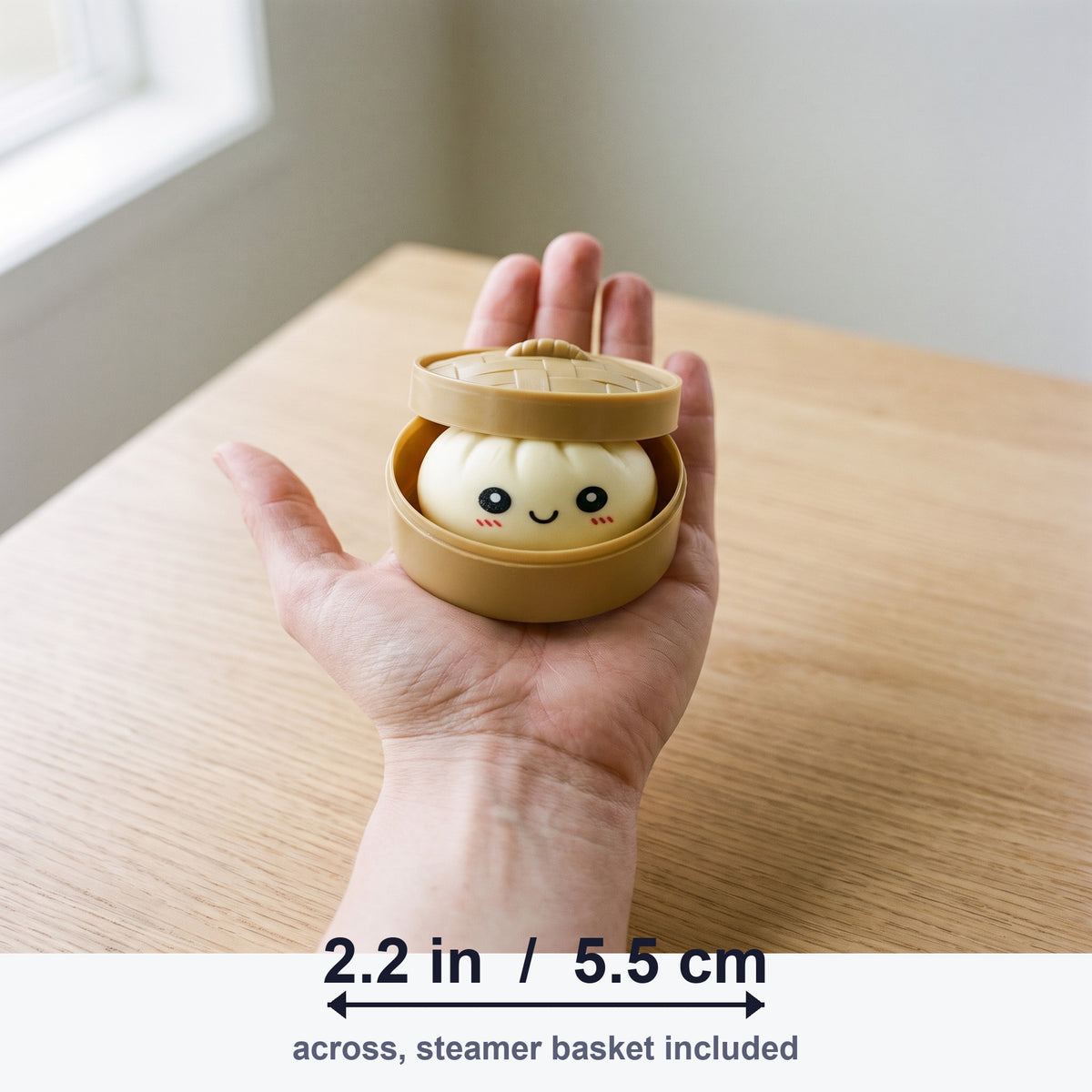 Dumpling squishy steamer basket held in a hand, 2.2 in / 5.5 cm across