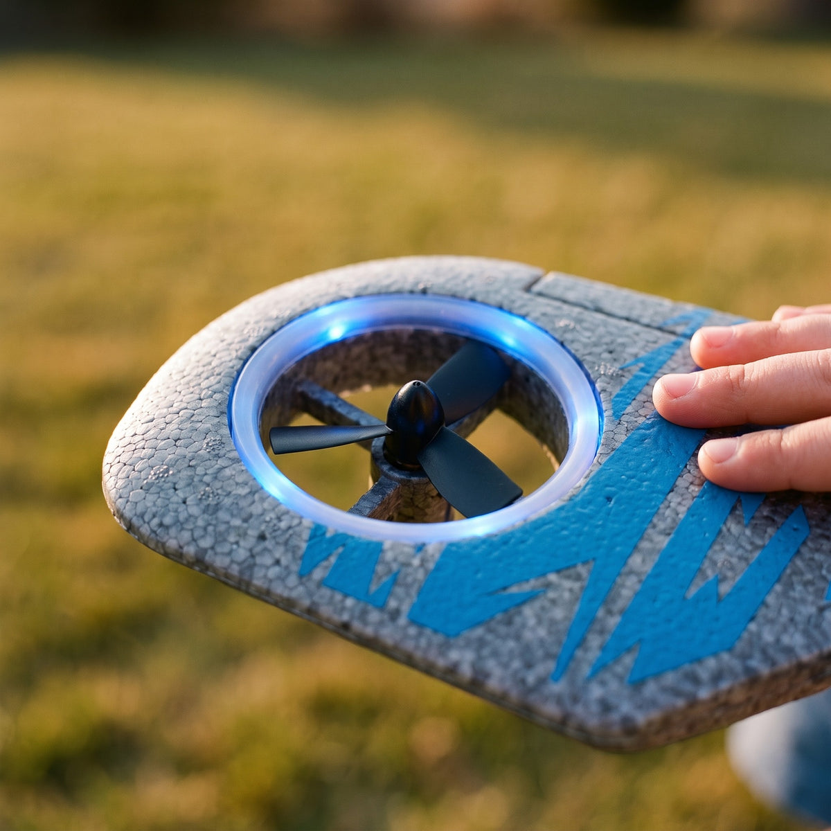 Close-up of the EPP foam wing and one lit rotor ring of the fighter jet