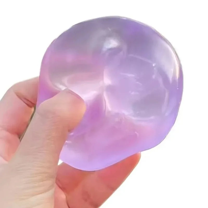 Purple squishy ball pressed flat, holding the dent