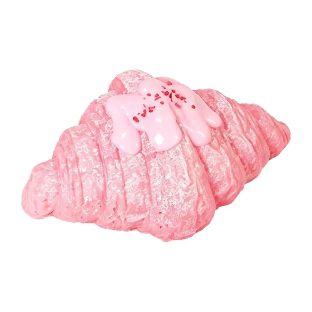 Pink croissant squishy toy on a white background