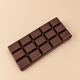 Chocolate bar squishy, chocolate brown bar with 15 squares on a plain caramel background