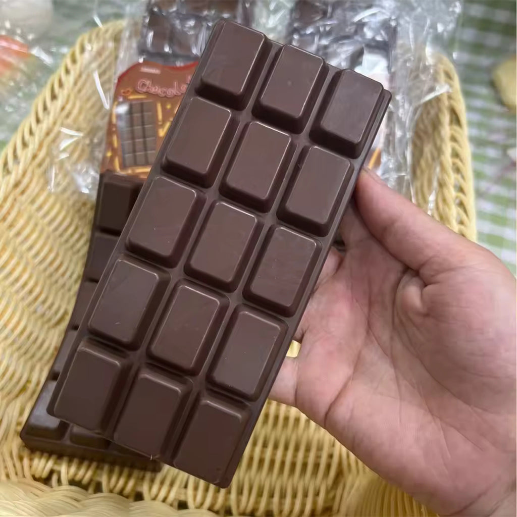 Chocolate bar squishy held flat in one hand, full-size bar