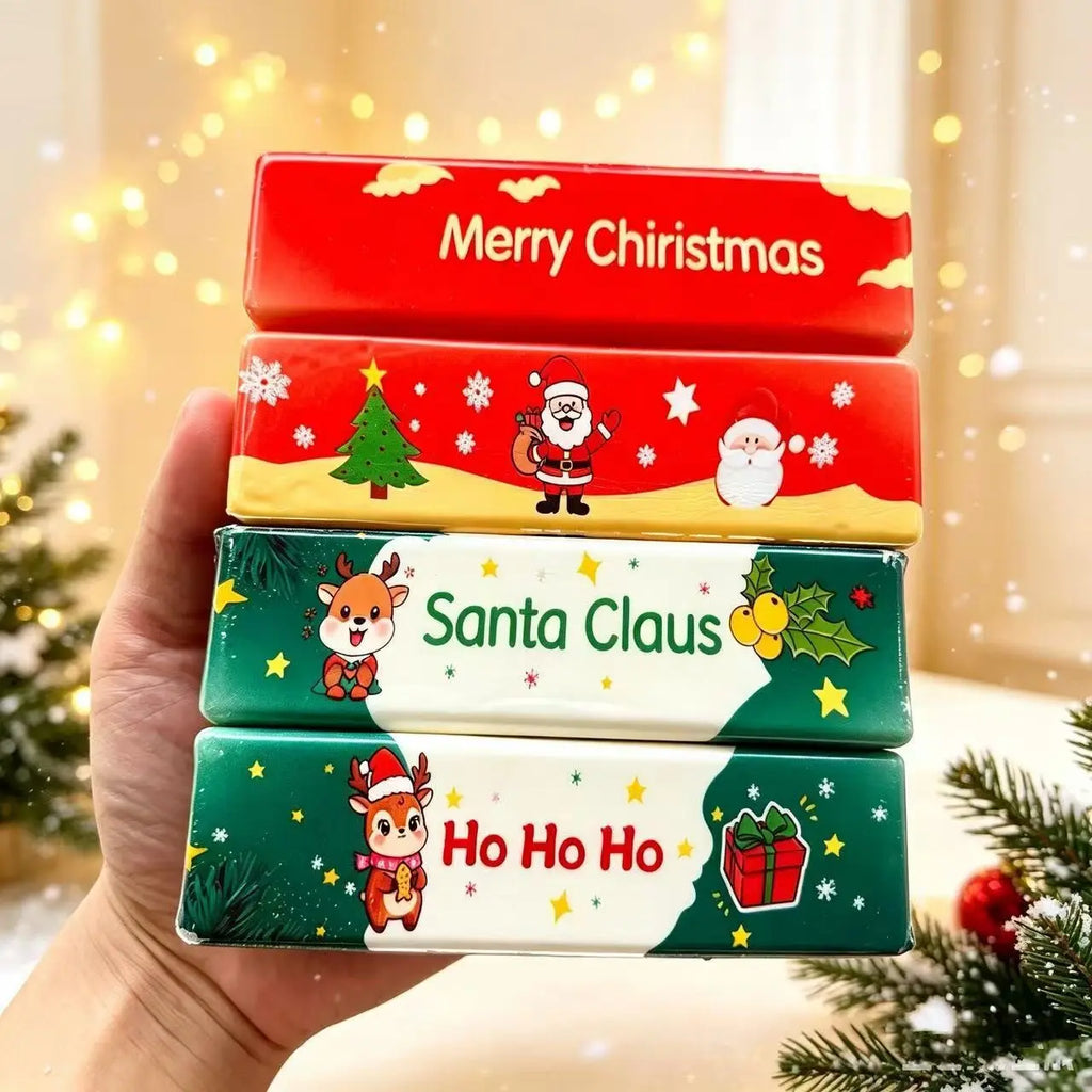 Red Merry Christmas and green Santa Claus Ho Ho Ho butter squishies stacked in one hand