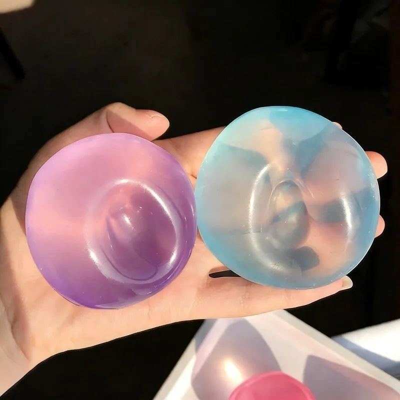 Purple and blue coconut oil squishies, both keeping the dent of a thumb