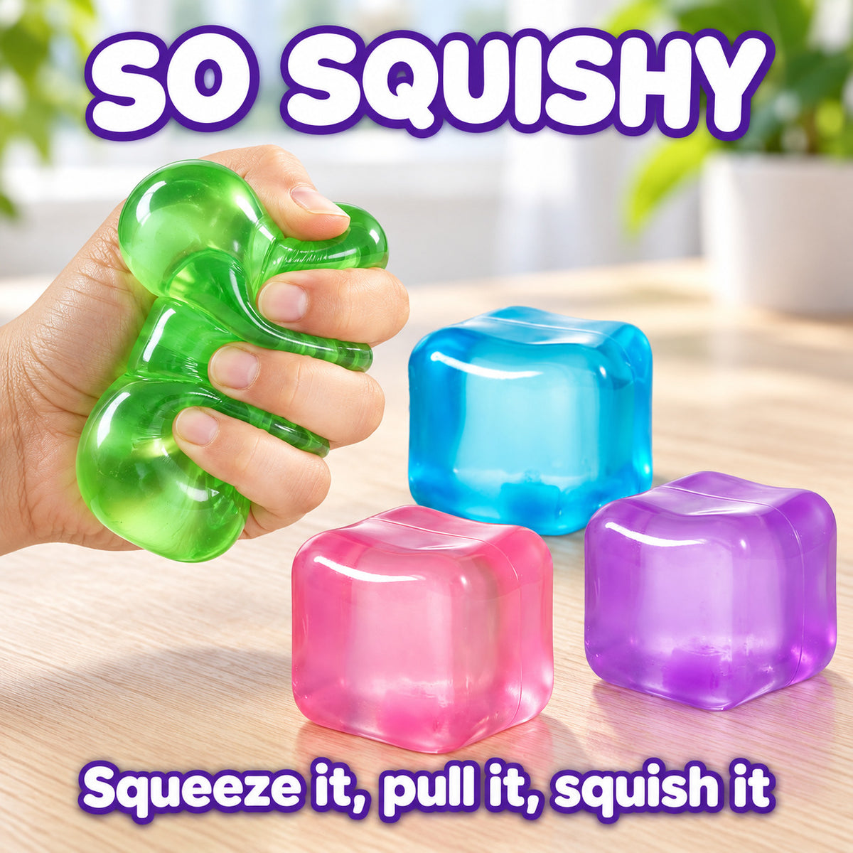 So squishy: a hand squeezes the green cube while the blue, pink and purple cubes wait on the desk