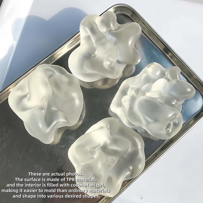 Four coconut oil squishies squeezed flat, holding their shape on a tray