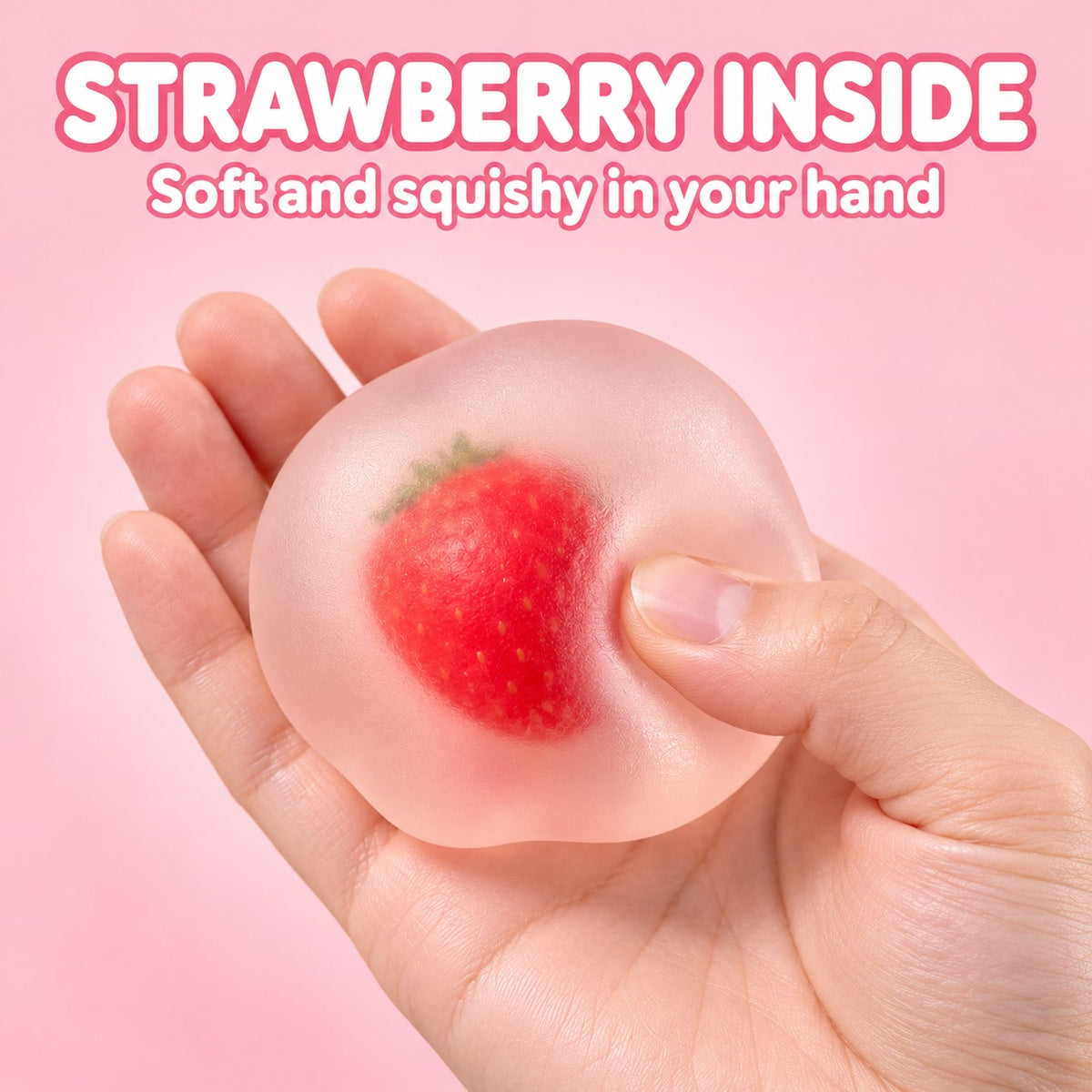Frosted squishy ball with a strawberry inside, held in one hand