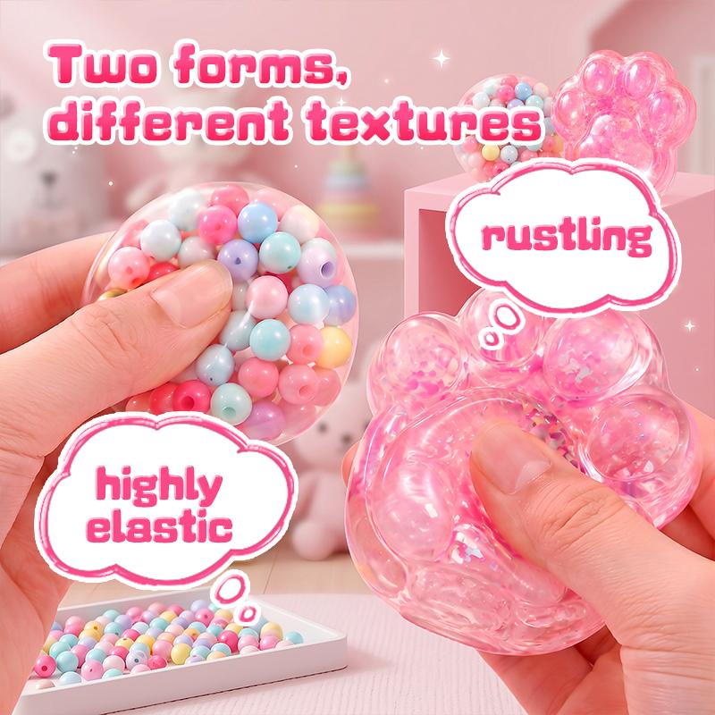 Two textures from the kit: a bead-filled ball that rustles and a stretchy gel cat paw