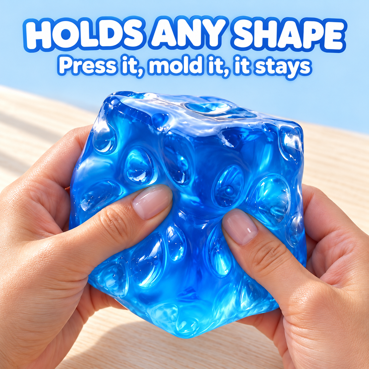 Two hands molding the jumbo blue jelly cheese cube squishy: holds any shape, press it, mold it, it stays