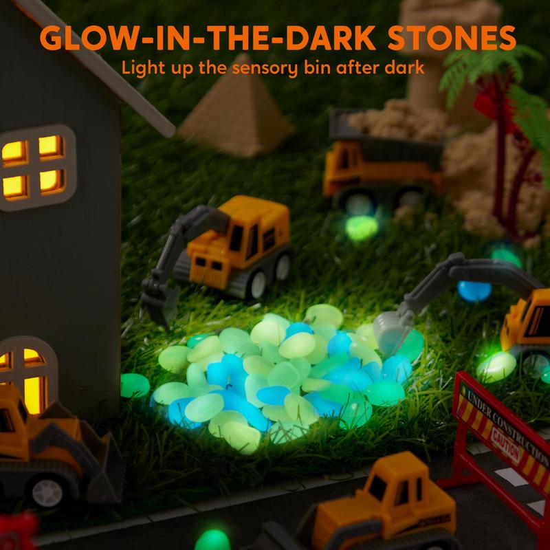 Glow-in-the-dark stones lighting up the sensory bin after dark