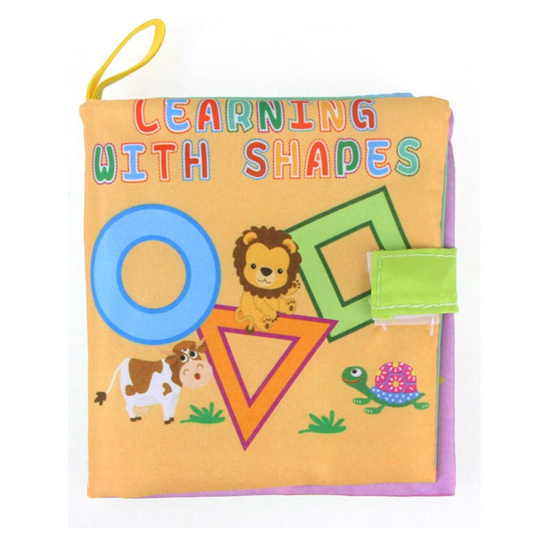 Learning With Shapes baby cloth book with an orange cover showing a lion, a cow, a turtle and colorful shapes