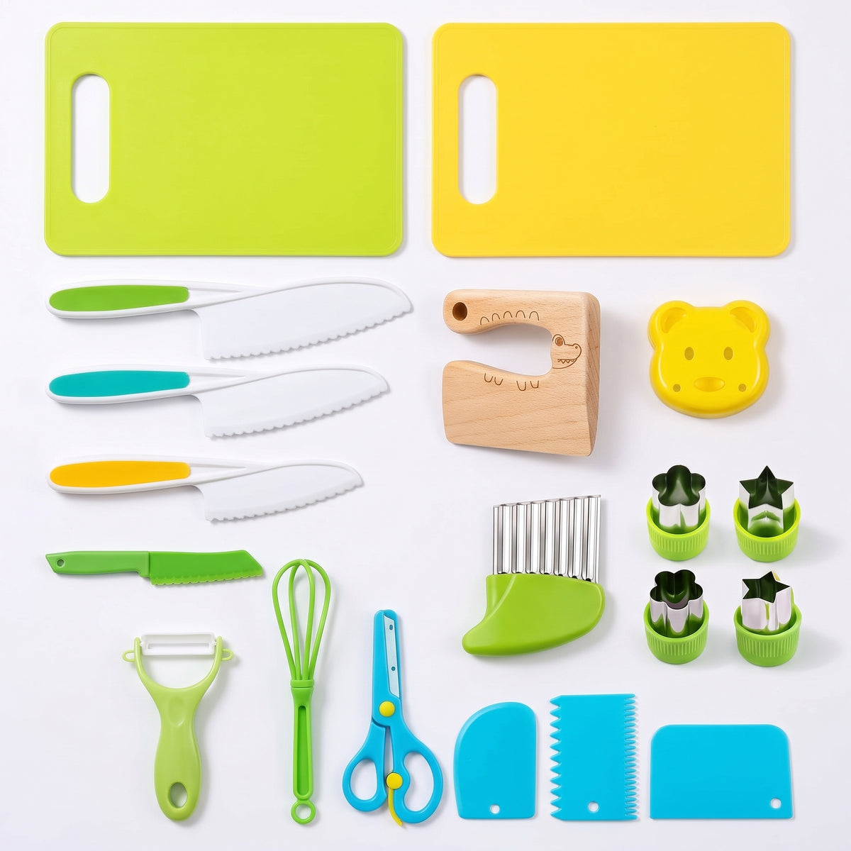 All nineteen pieces of the kitchen set laid out on white: two boards, three nylon knives, the beech crocodile knife, peeler, tongs, scissors, crinkle cutter, bear press, four shape cutters and three dough scrapers