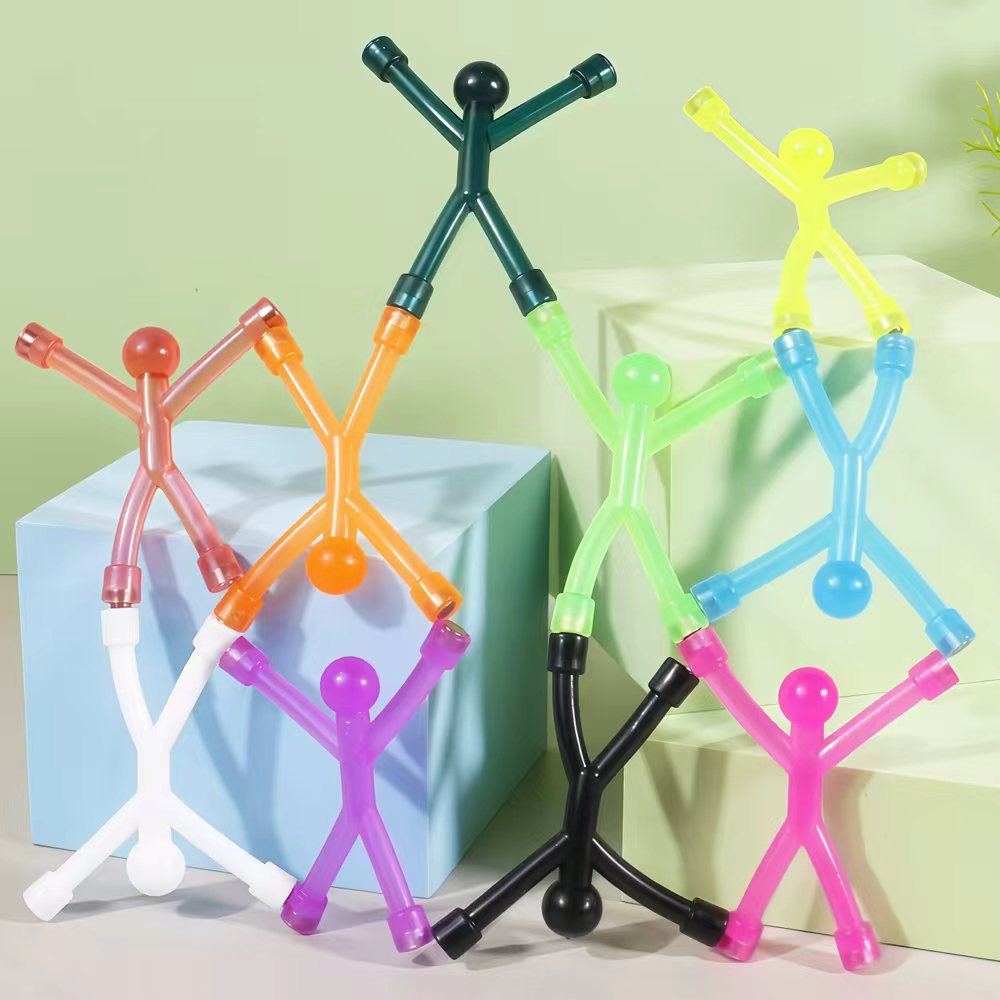 Bendy magnetic stick figures standing and leaning against blocks, ten colours