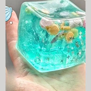 Ocean ice cube squishy held in a hand