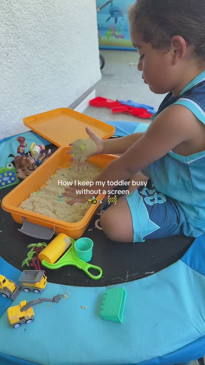 Toddler playing in the kinetic sand sensory bin without a screen