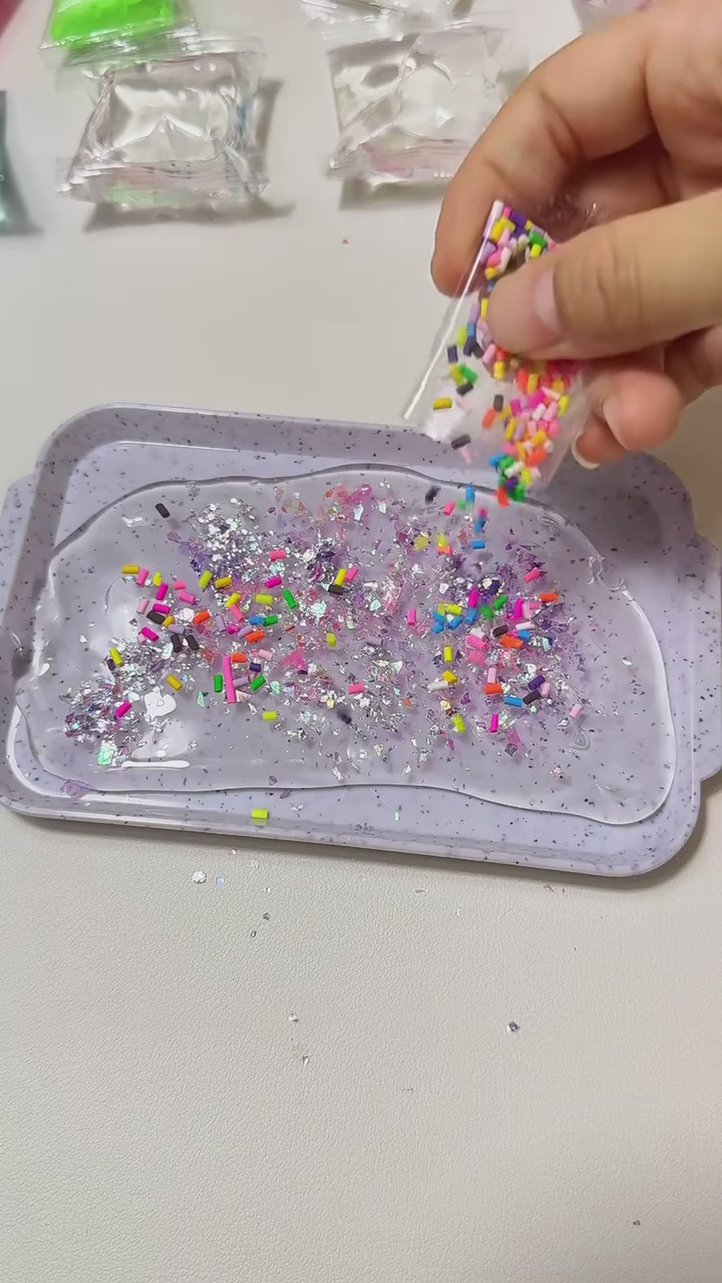Filling a cat paw mould with gel, glitter and beads, then squeezing the finished squishy