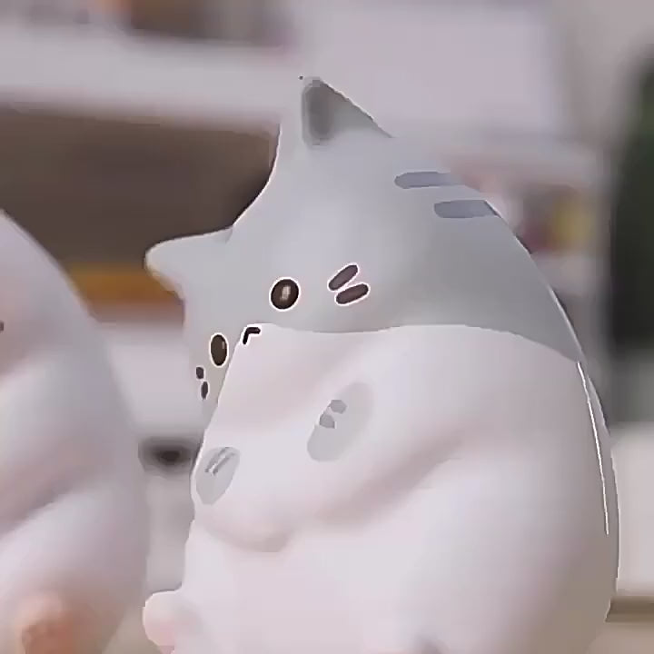 Kawaii cat squishies squeezed flat by hand and coming back to shape