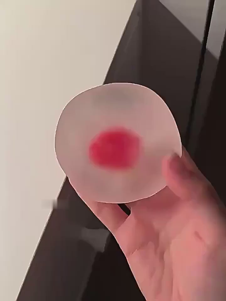 Hand squeezing the crystal strawberry squishy, the dents stay for a while