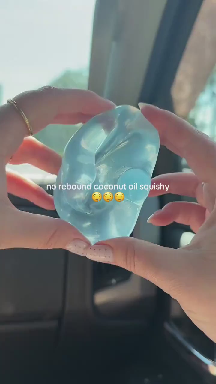 Hands squeezing a blue coconut oil squishy ball, the shape stays