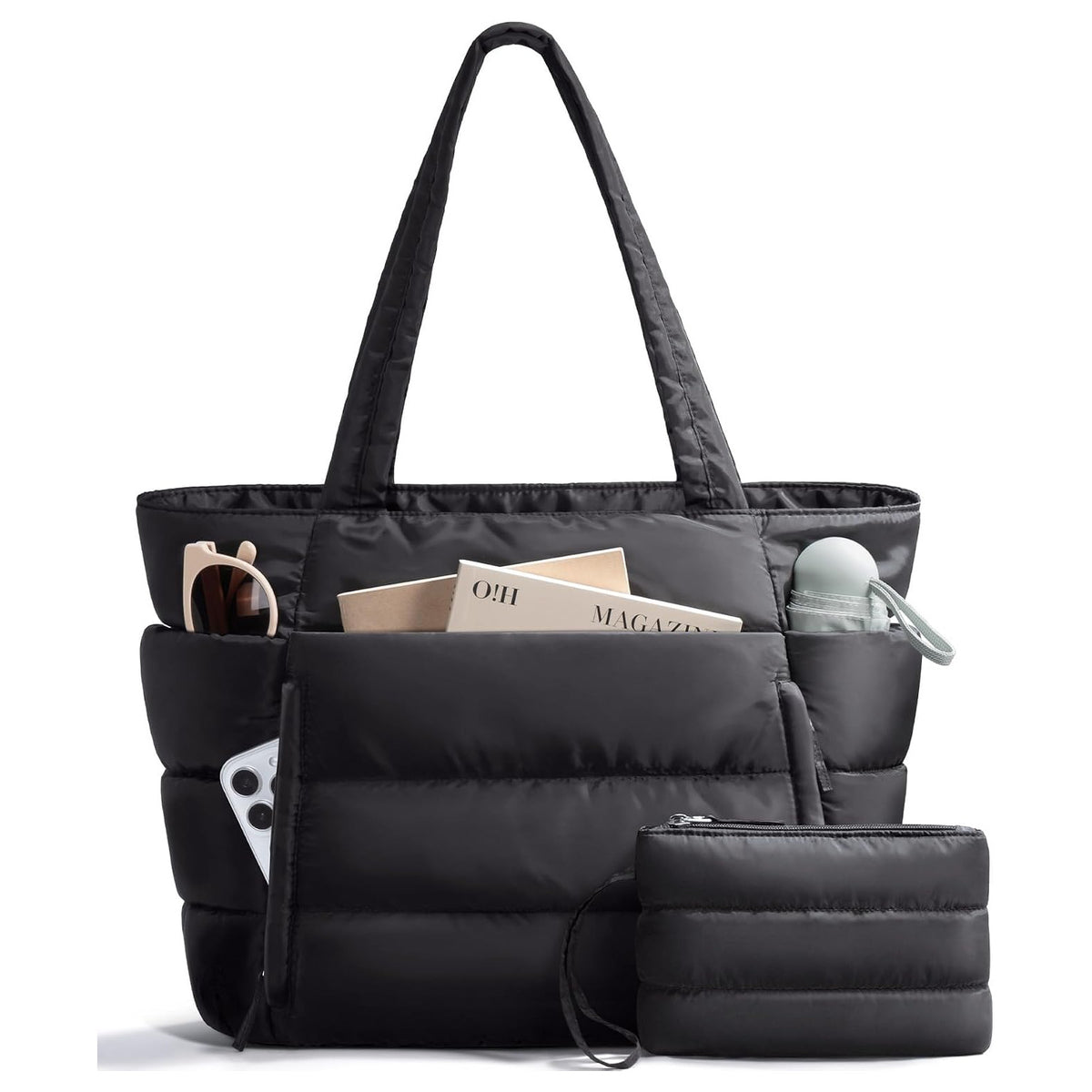 Black puffer tote bag with its matching pouch, packed with a magazine, sunglasses, a phone and a water bottle in the side pocket