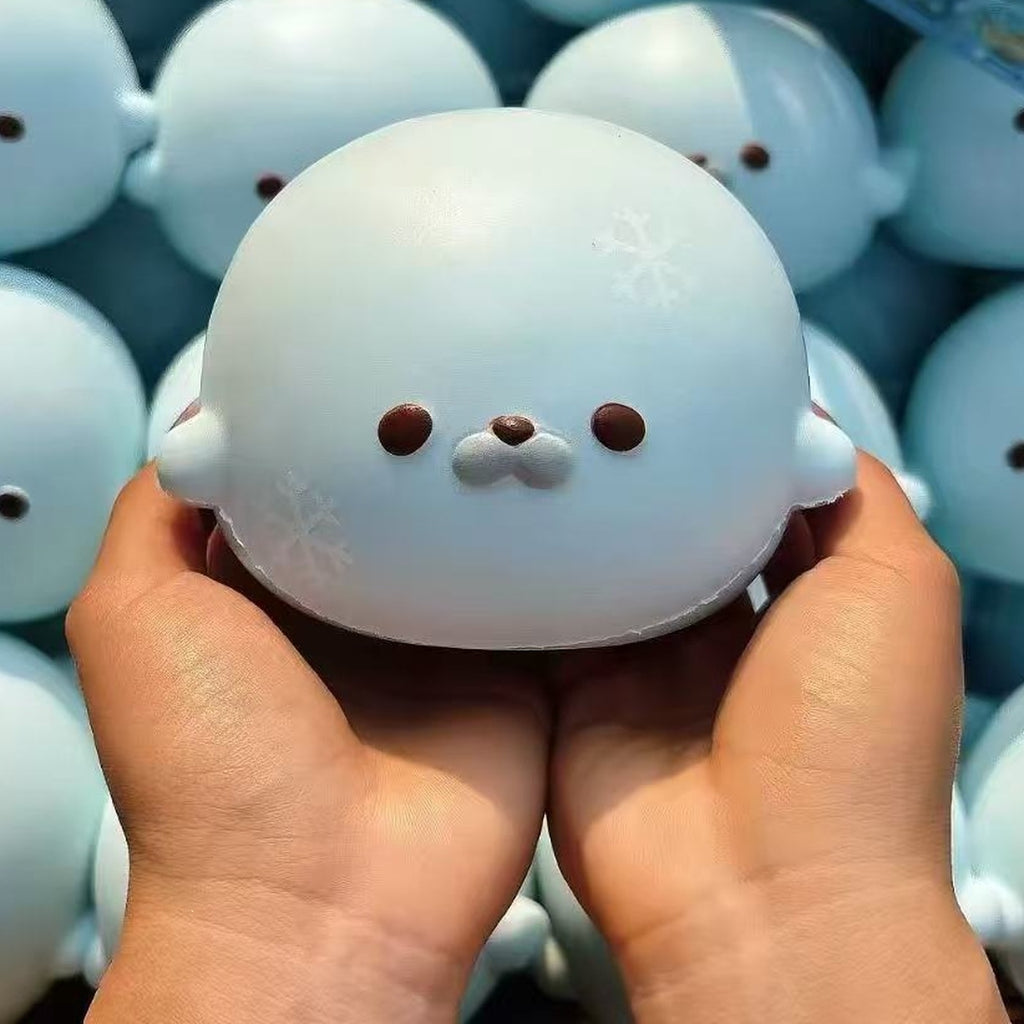 Sky blue seal squishy with snowflakes, cupped in two hands