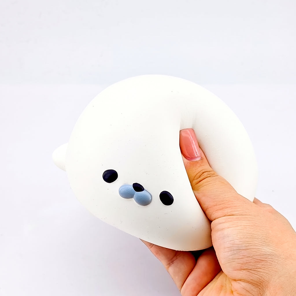 Thumb pressing a dent into the seal squishy