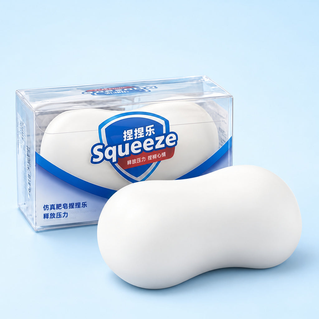 White squishy soap bar in front of its clear Squeeze box