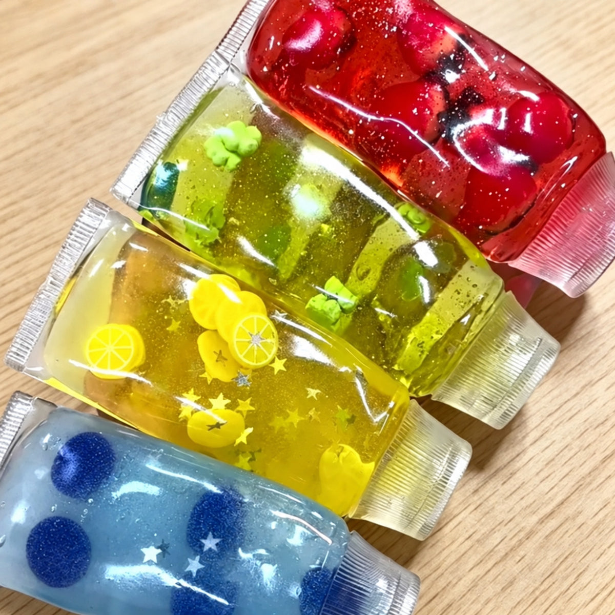 Toothpaste tube squishy in four styles: strawberry red, clover green, lemon yellow and blueberry blue