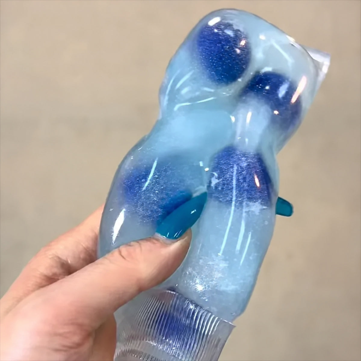Blueberry Blue toothpaste tube squishy squeezed in one hand