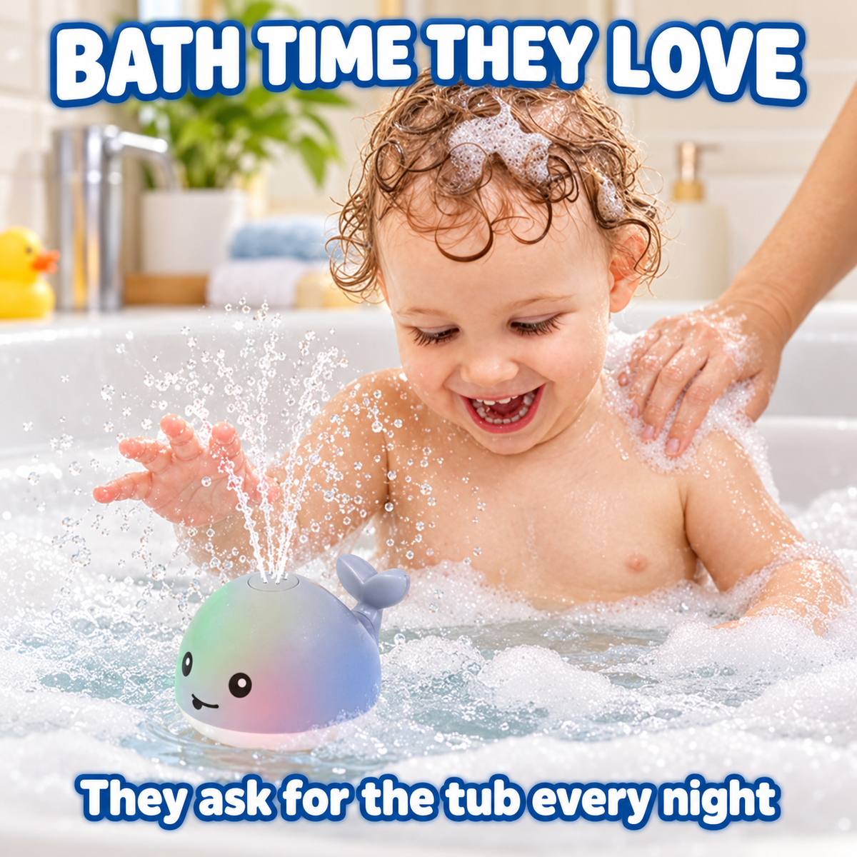 Toddler laughing at the whale fountain at bath time