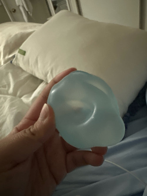 Customer photo of a coconut oil squishy ball held in one hand