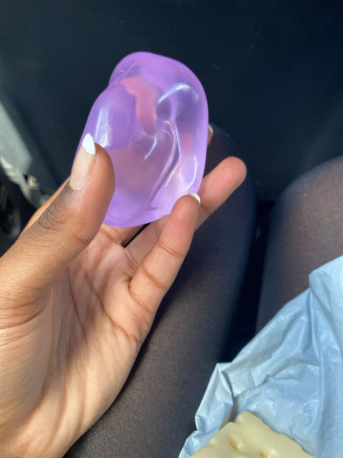Customer photo of a coconut oil squishy ball held in one hand