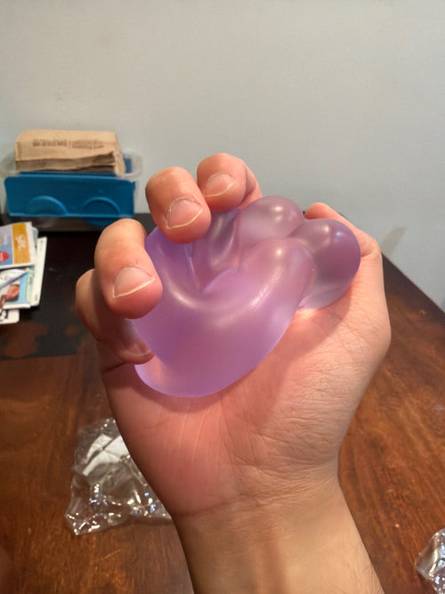 Customer photo of a coconut oil squishy ball held in one hand